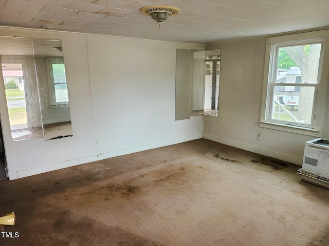 spare room with baseboards and ornamental molding
