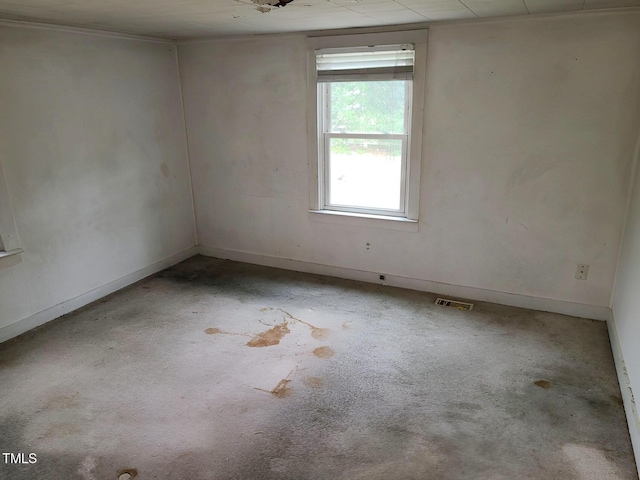 unfurnished room featuring baseboards and visible vents