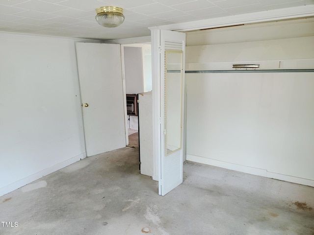 unfurnished bedroom featuring unfinished concrete flooring