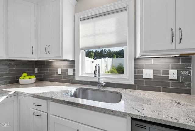 110 Deacon Ridge Ln, Youngsville, NC 27596 - kitchen with white cabinetry, a sink, dishwashing machine, and tasteful backsplash
