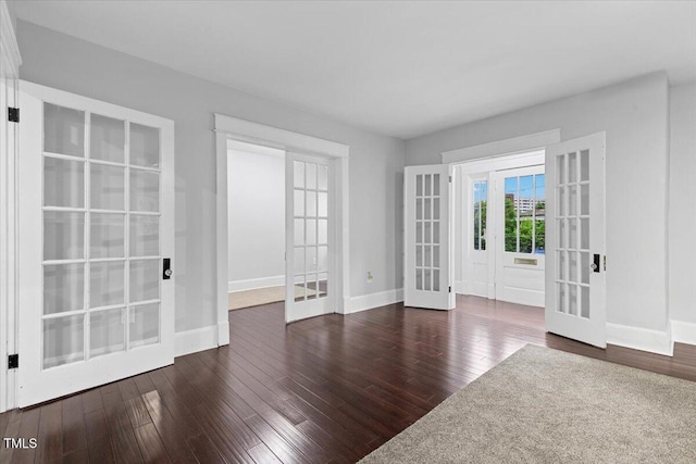 interior space featuring baseboards, french doors, and dark wood finished floors
