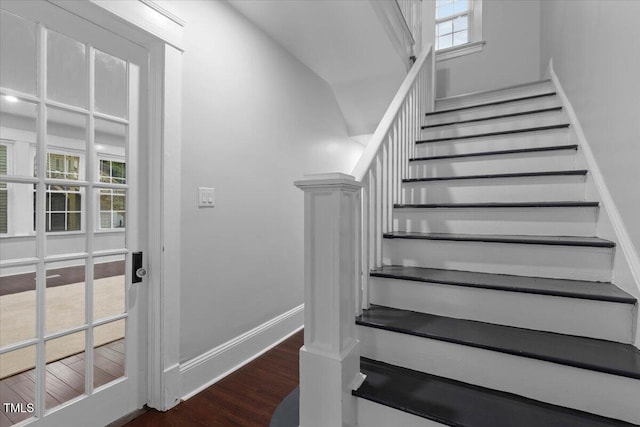 stairway featuring baseboards and wood finished floors