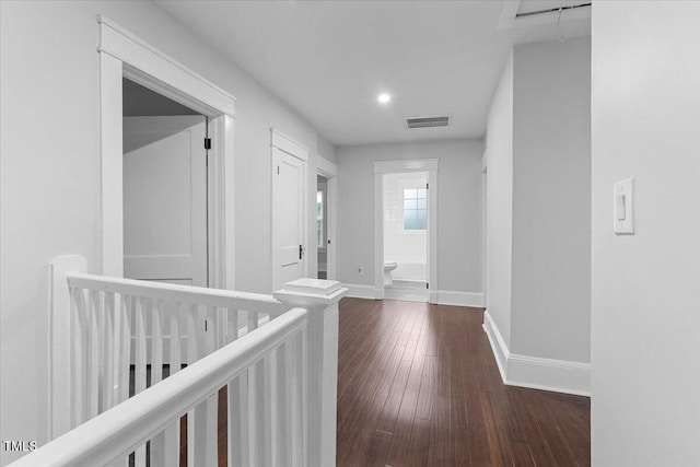 hall with recessed lighting, baseboards, dark wood-style floors, and visible vents