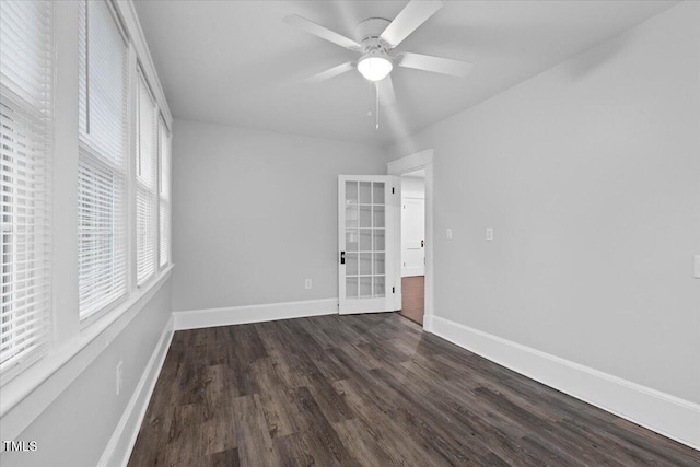 unfurnished bedroom with baseboards, a ceiling fan, and dark wood-type flooring