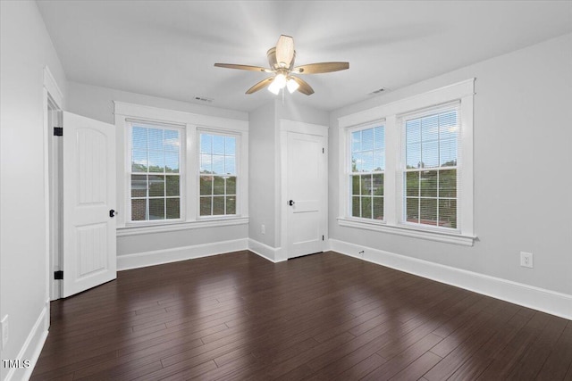 spare room with baseboards, a ceiling fan, and a wealth of natural light