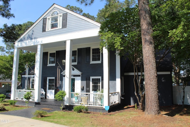 greek revival house featuring a porch