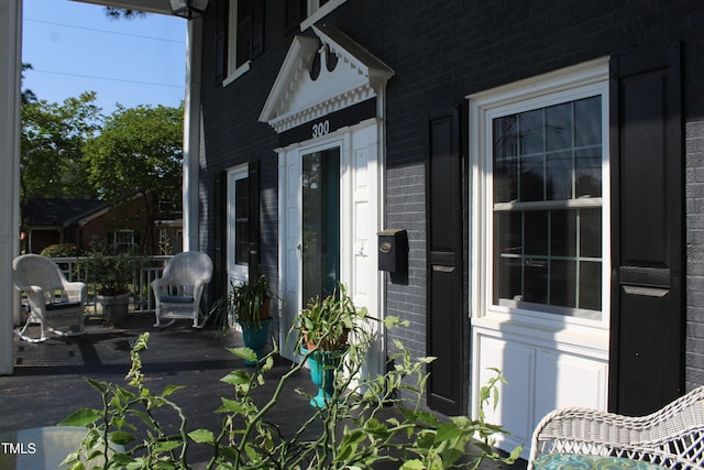 property entrance featuring brick siding