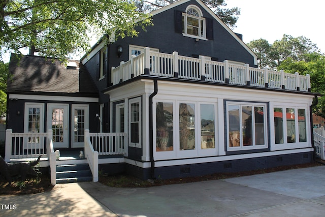 back of house featuring a balcony and crawl space