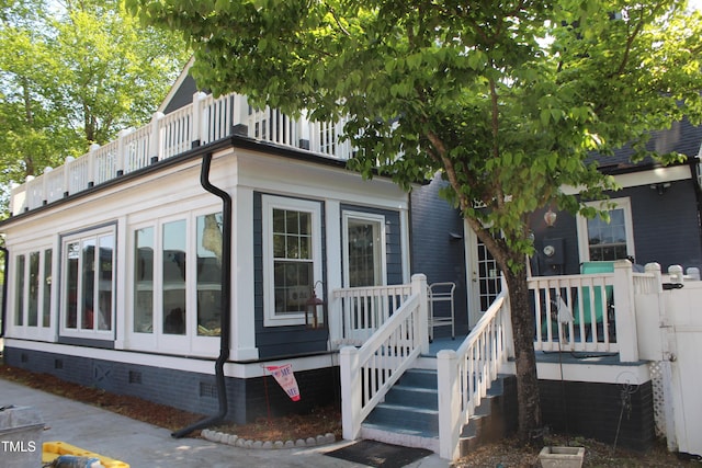 exterior space featuring a balcony and crawl space