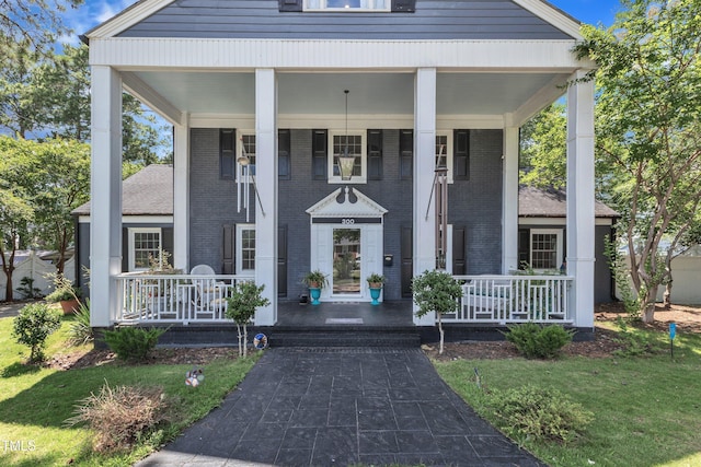 300 S Pine St, Benson, NC 27504 - view of front facade featuring a porch, brick siding, and a front yard