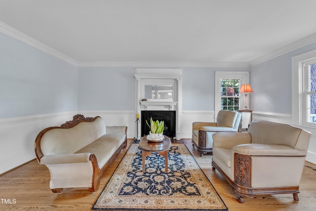 300 S Pine St, Benson, NC 27504 - living room featuring healthy amount of natural light, wood finished floors, ornamental molding, and a fireplace with flush hearth