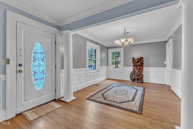 300 S Pine St, Benson, NC 27504 - entryway with decorative columns, a wainscoted wall, a chandelier, wood finished floors, and crown molding