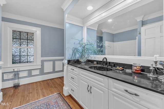 300 S Pine St, Benson, NC 27504 - bathroom featuring vanity, wood finished floors, ornamental molding, and wainscoting