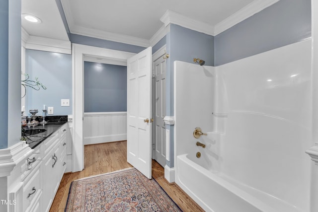 300 S Pine St, Benson, NC 27504 - full bath featuring wood finished floors, vanity, shower / tub combination, ornamental molding, and wainscoting