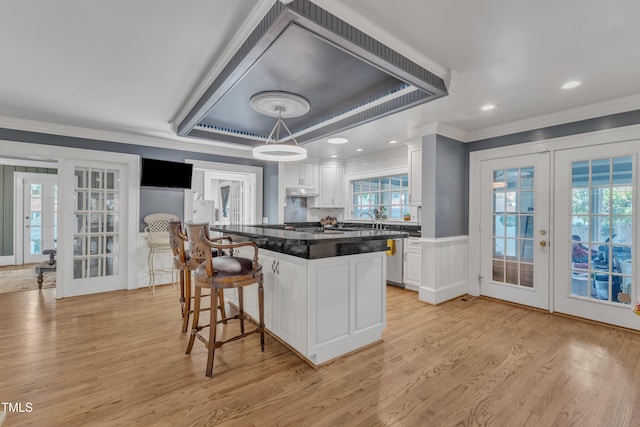 300 S Pine St, Benson, NC 27504 - kitchen with french doors, ornamental molding, light wood-type flooring, and white cabinets