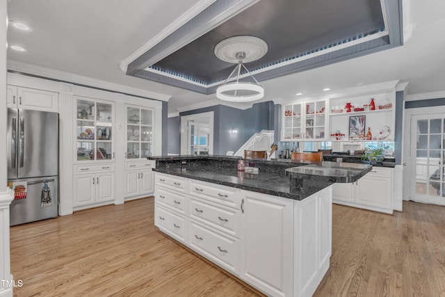 300 S Pine St, Benson, NC 27504 - kitchen with freestanding refrigerator, light wood finished floors, white cabinets, glass insert cabinets, and crown molding