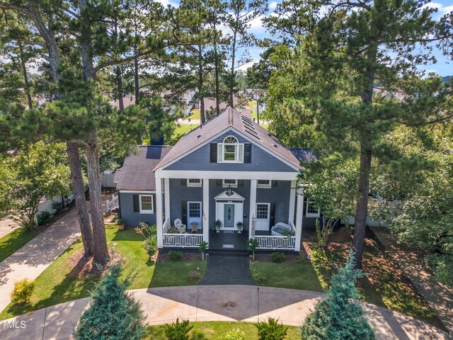 300 S Pine St, Benson, NC 27504 - greek revival house with covered porch, stucco siding, a front yard, and roof with shingles