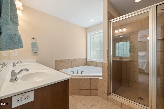 bathroom with a sink, tile patterned flooring, a garden tub, and a stall shower