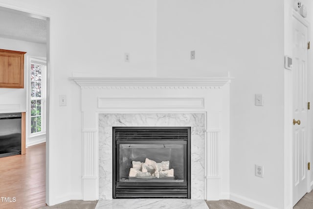 7109 Spanglers Spring Way, Raleigh, NC 27610 - details featuring black dishwasher, baseboards, and a high end fireplace