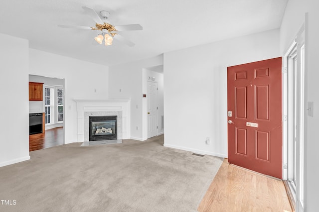 7109 Spanglers Spring Way, Raleigh, NC 27610 - unfurnished living room with visible vents, baseboards, a ceiling fan, carpet, and a premium fireplace