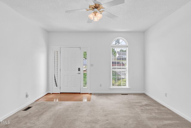 7109 Spanglers Spring Way, Raleigh, NC 27610 - entryway with ceiling fan, a textured ceiling, visible vents, baseboards, and carpet flooring