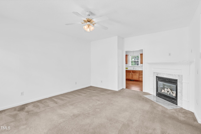 7109 Spanglers Spring Way, Raleigh, NC 27610 - unfurnished living room featuring ceiling fan, a fireplace, a sink, baseboards, and carpet flooring