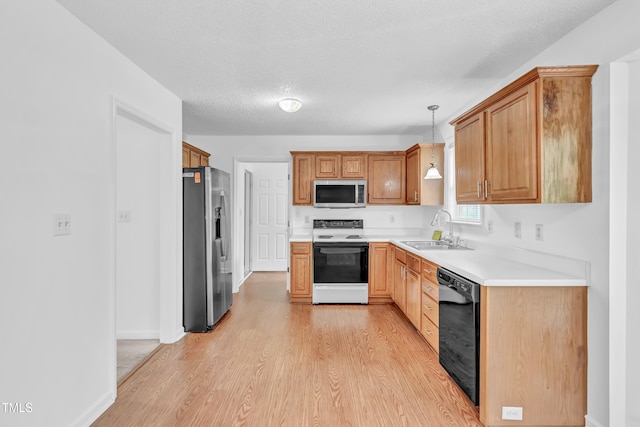 7109 Spanglers Spring Way, Raleigh, NC 27610 - kitchen with decorative light fixtures, a sink, light countertops, light wood-style floors, and stainless steel appliances