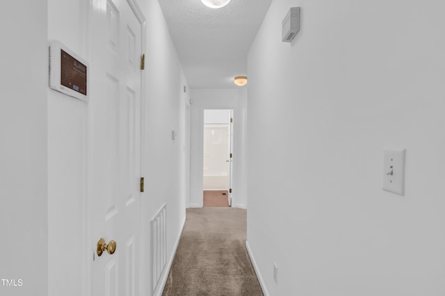7109 Spanglers Spring Way, Raleigh, NC 27610 - corridor with baseboards, carpet, a textured ceiling, and visible vents