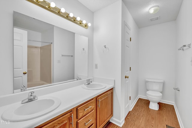 7109 Spanglers Spring Way, Raleigh, NC 27610 - full bath with a sink, toilet, wood finished floors, and visible vents