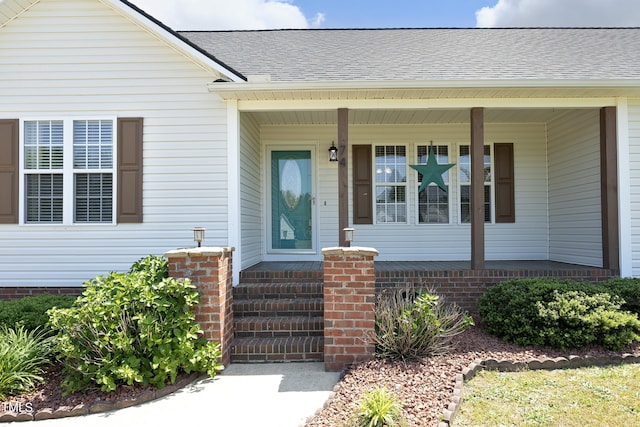 property entrance featuring a shingled roof and a porch