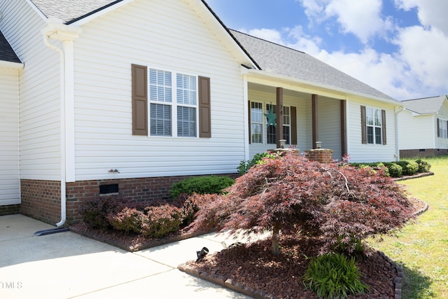 view of front of home with a porch, crawl space, and a shingled roof