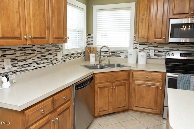 74 Pedernales Dr, Smithfield, NC 27577 - kitchen with light tile patterned flooring, appliances with stainless steel finishes, a sink, light countertops, and decorative backsplash