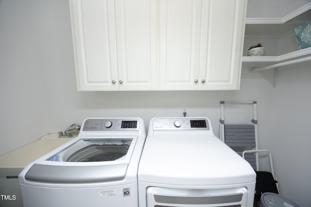 washroom with independent washer and dryer and cabinet space