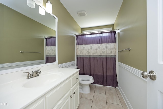 full bath featuring vanity, tile patterned flooring, toilet, and curtained shower