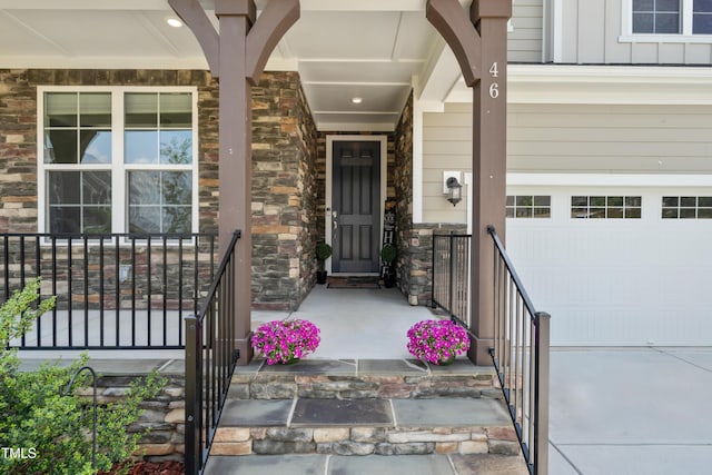 46 Waterfall Pointe, Chapel Hill, NC 27517 - view of exterior entry with a porch, stone siding, and a garage