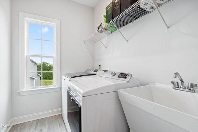 46 Waterfall Pointe, Chapel Hill, NC 27517 - laundry room with laundry area, light wood-type flooring, a sink, baseboards, and washer and clothes dryer