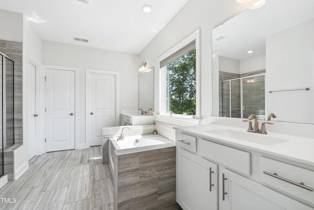 46 Waterfall Pointe, Chapel Hill, NC 27517 - full bath with visible vents, a bath, two vanities, a sink, and a stall shower