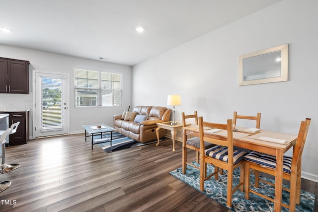 dining space with dark wood finished floors, recessed lighting, and baseboards