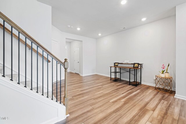 foyer entrance with light wood-style floors, recessed lighting, baseboards, and stairs