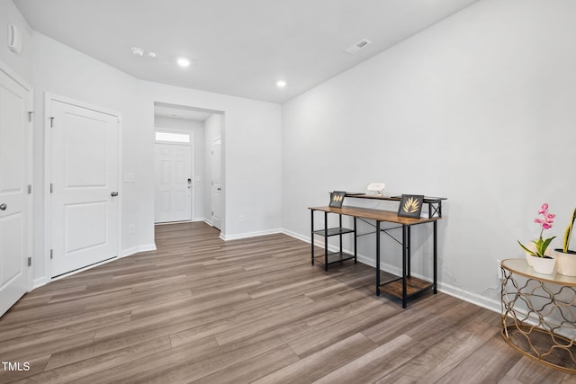 interior space with wood finished floors, baseboards, and recessed lighting