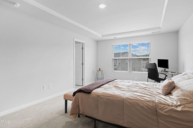 bedroom featuring carpet flooring, a tray ceiling, and baseboards