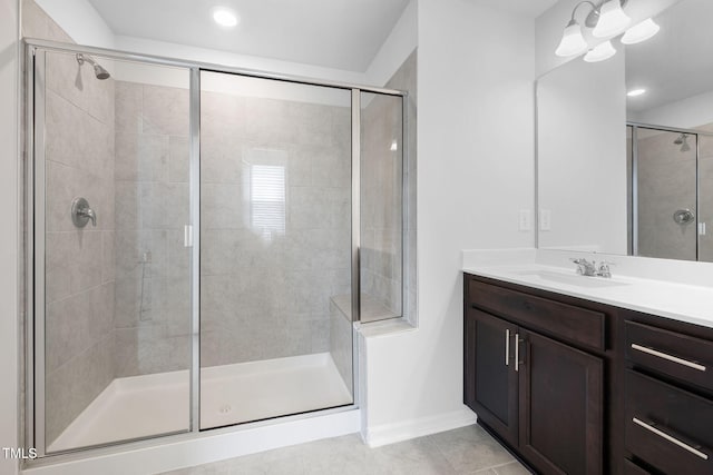 full bathroom featuring a shower stall, tile patterned floors, vanity, baseboards, and recessed lighting