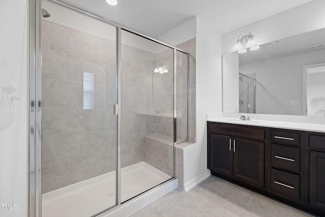 bathroom featuring a stall shower, tile patterned flooring, and vanity