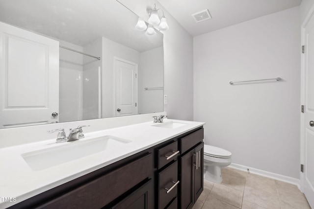 full bathroom with toilet, baseboards, double vanity, tile patterned flooring, and a shower