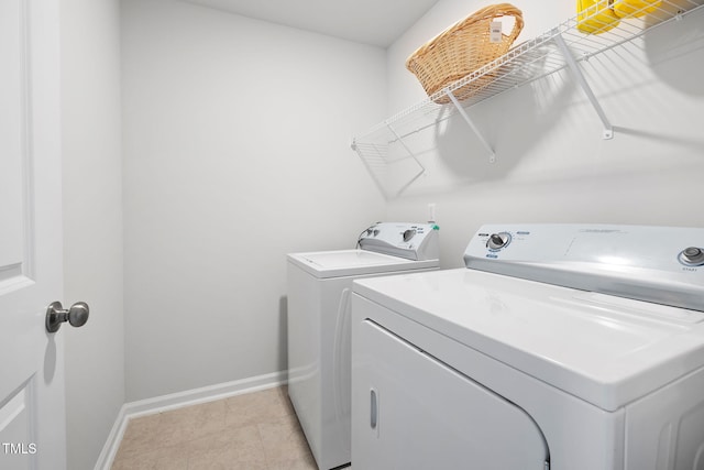 laundry room featuring independent washer and dryer, baseboards, and light tile patterned floors
