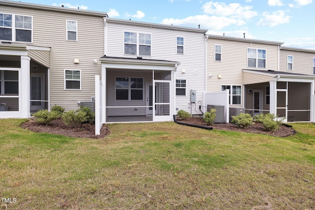back of house featuring a sunroom and a yard