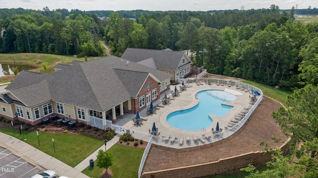 drone / aerial view of a forest and a pool