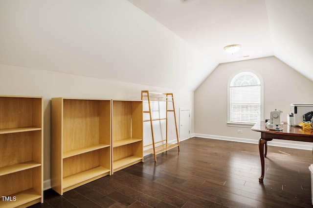 additional living space with baseboards, dark wood finished floors, and lofted ceiling