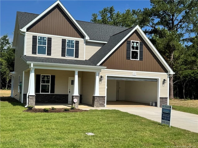 303 Hendrix B Rd, Raeford, NC 28376 - craftsman house with concrete driveway, stone siding, a porch, a shingled roof, and a garage