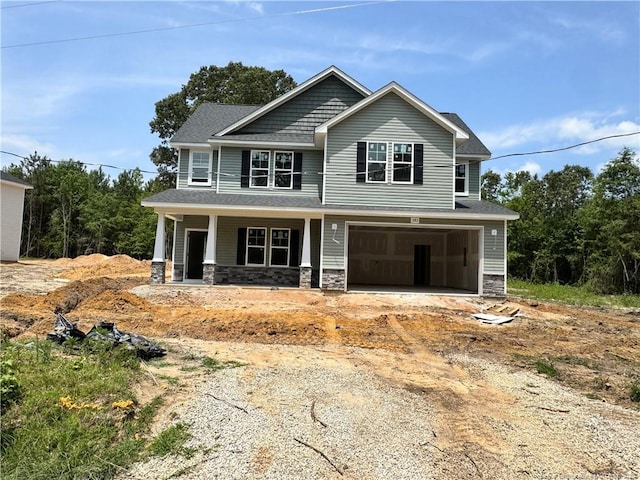 393 Hendrix D Rd, Raeford, NC 28376 - craftsman inspired home featuring stone siding, a porch, driveway, and a garage